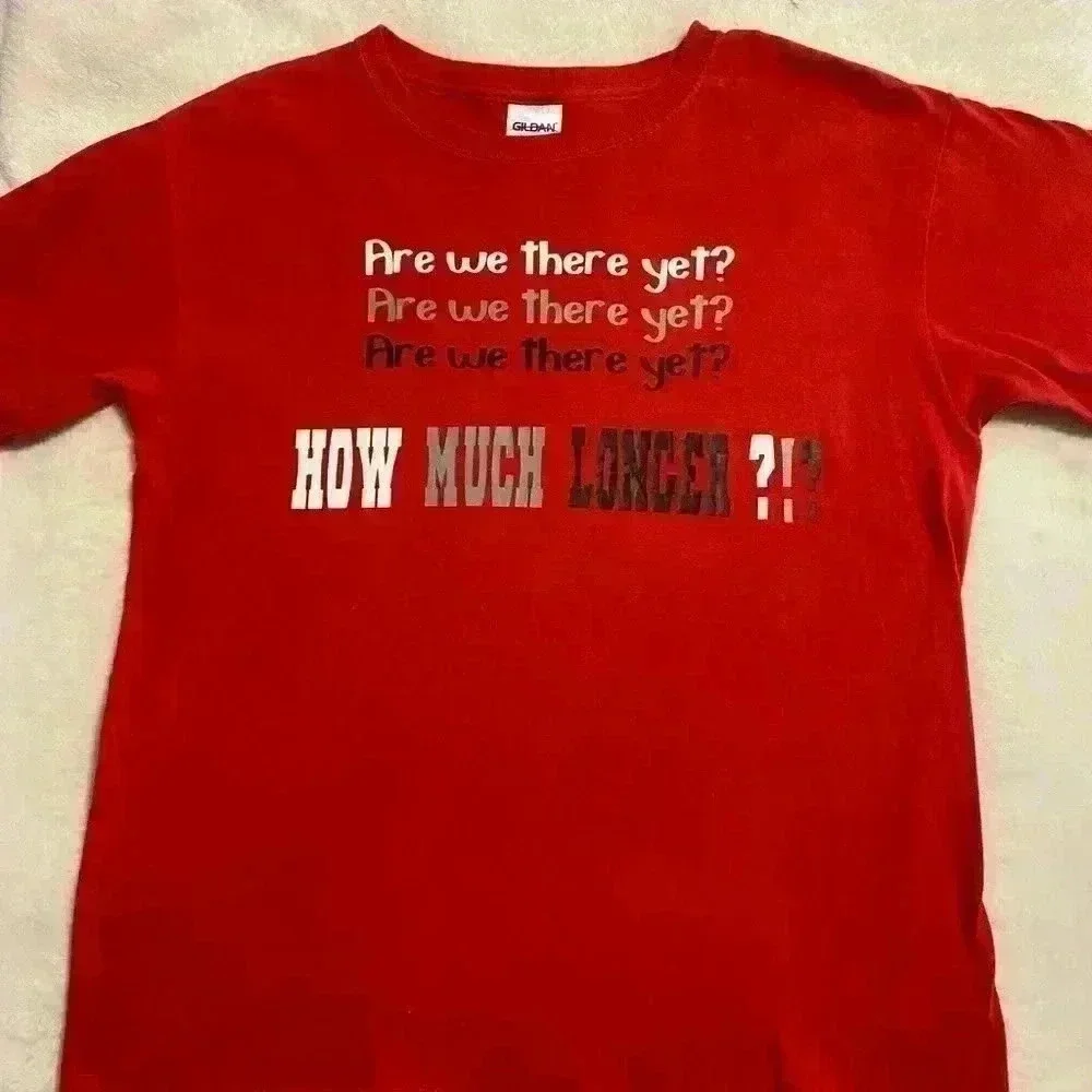 2 Boys T shirts in red ARE WE THERE YET HOW MUCH LONGER sizes Medium & Large.